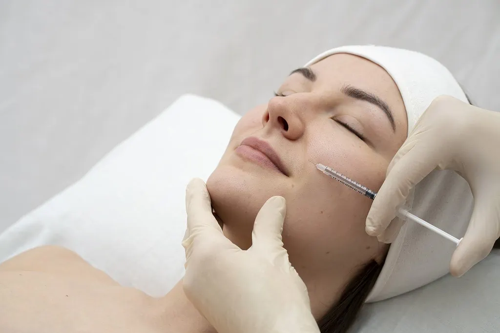 Close-up of woman receiving facial injection for cosmetic skin treatment.